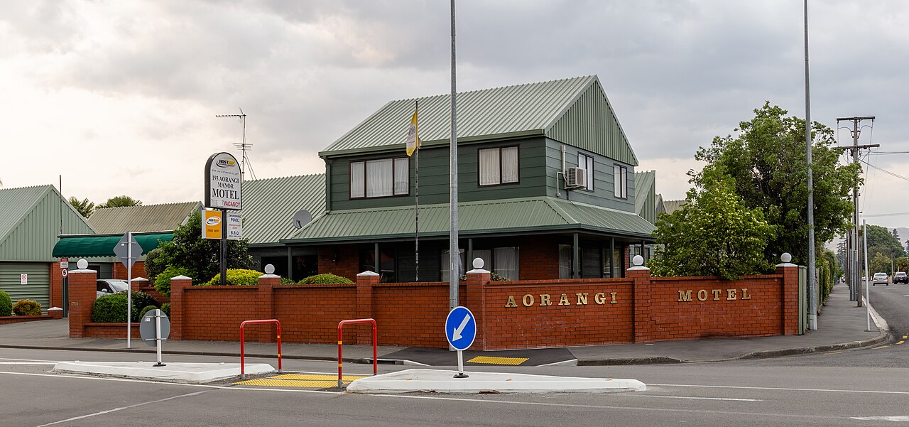 A single-level motel row at dusk